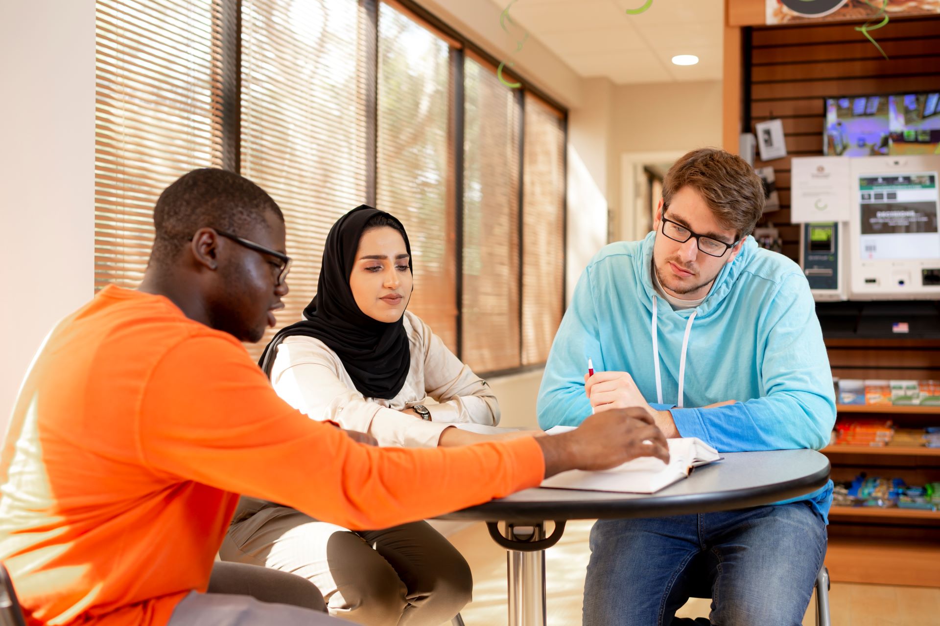 Three students studying together at a table